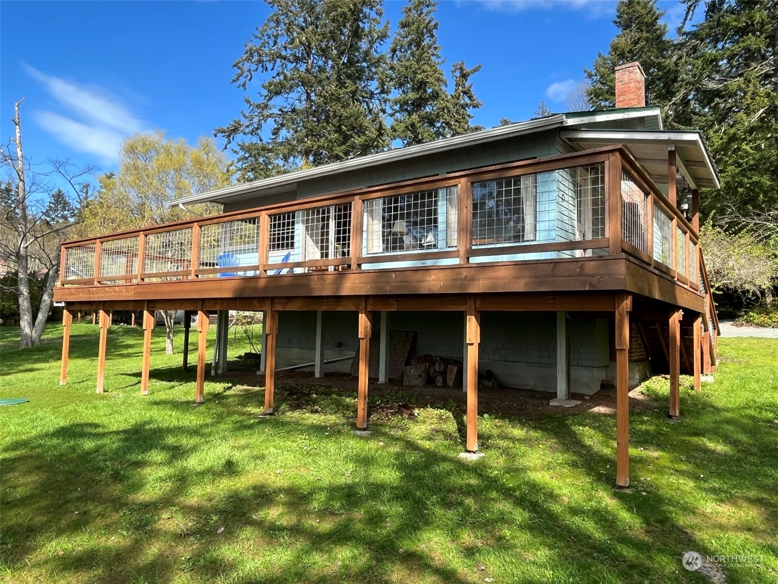 509 Spring Street Camano Island, WA 98282 - Photo 2 of 28 a front view of a house with a garden