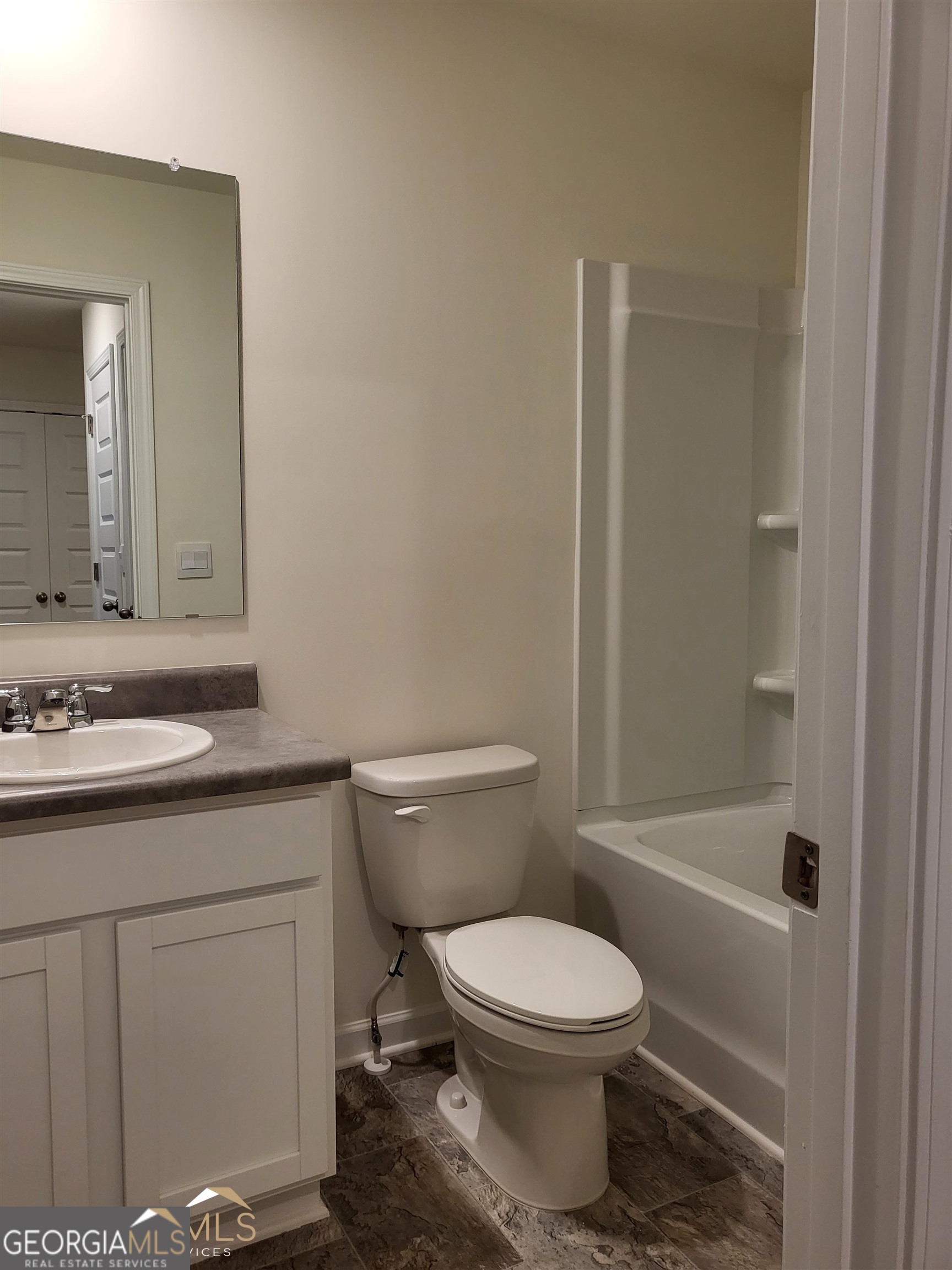 839 Taurus Drive Stockbridge, GA 30281 - Photo 23 of 27 a bathroom with a granite countertop toilet a sink and a bathtub