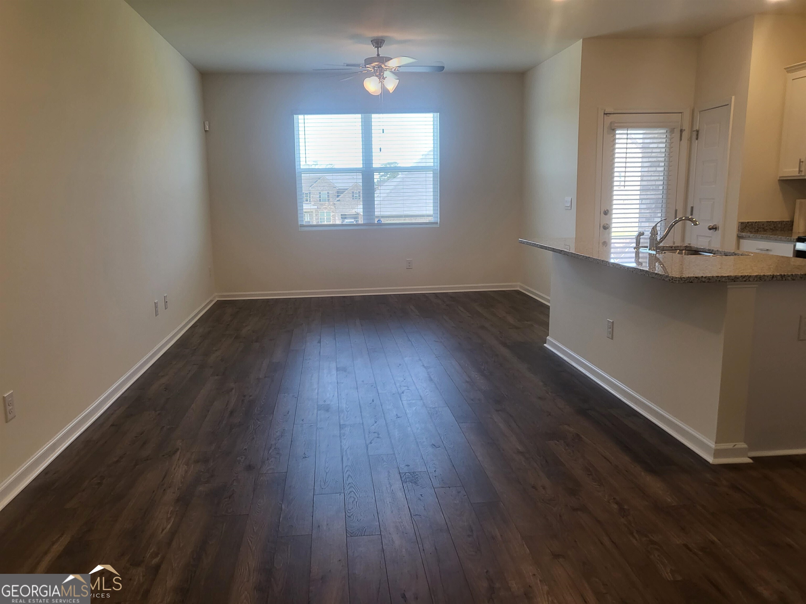 839 Taurus Drive Stockbridge, GA 30281 - Photo 3 of 27 an empty room with wooden floor and windows