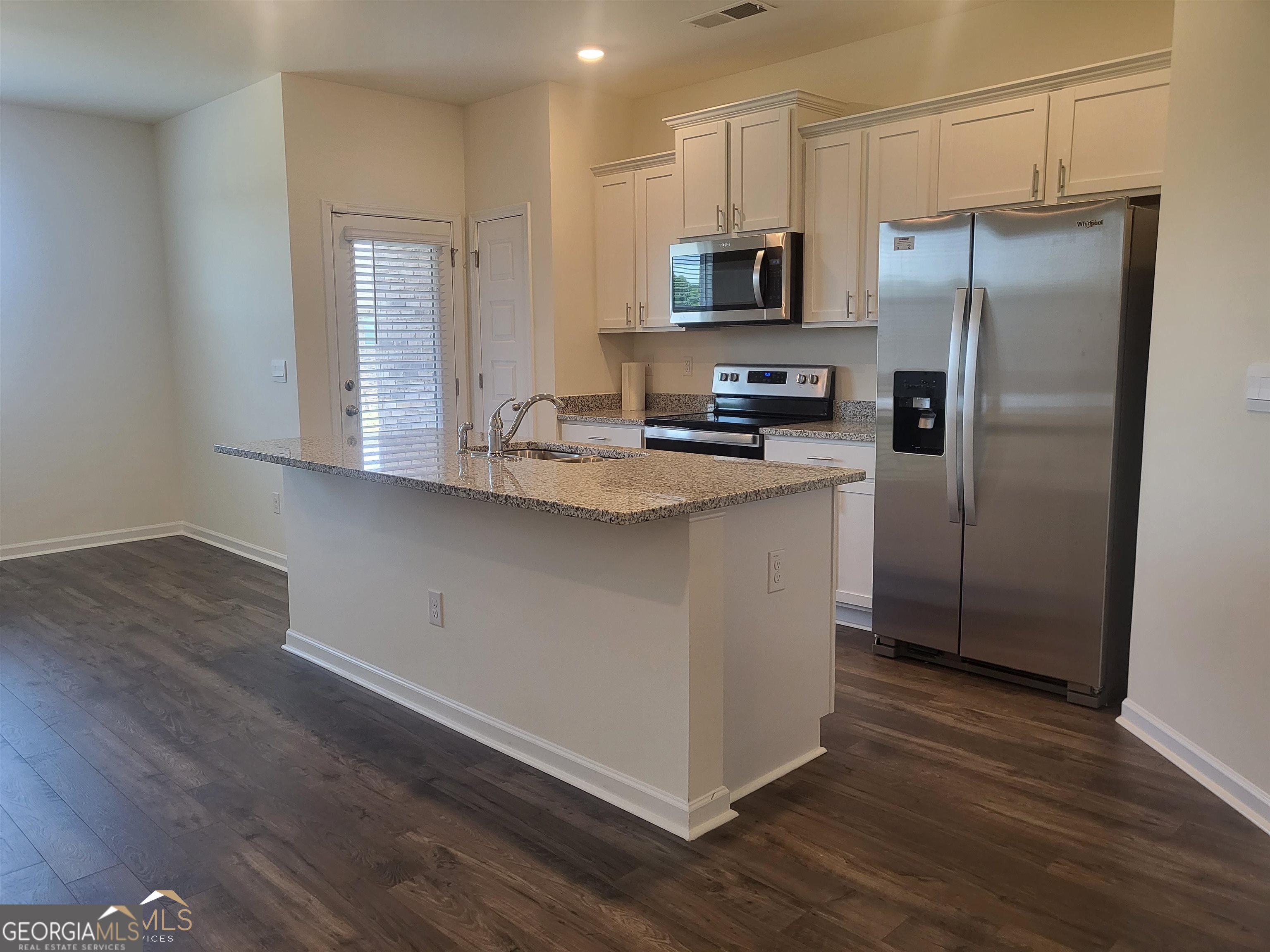 839 Taurus Drive Stockbridge, GA 30281 - Photo 4 of 27 a kitchen with stainless steel appliances a refrigerator microwave and sink