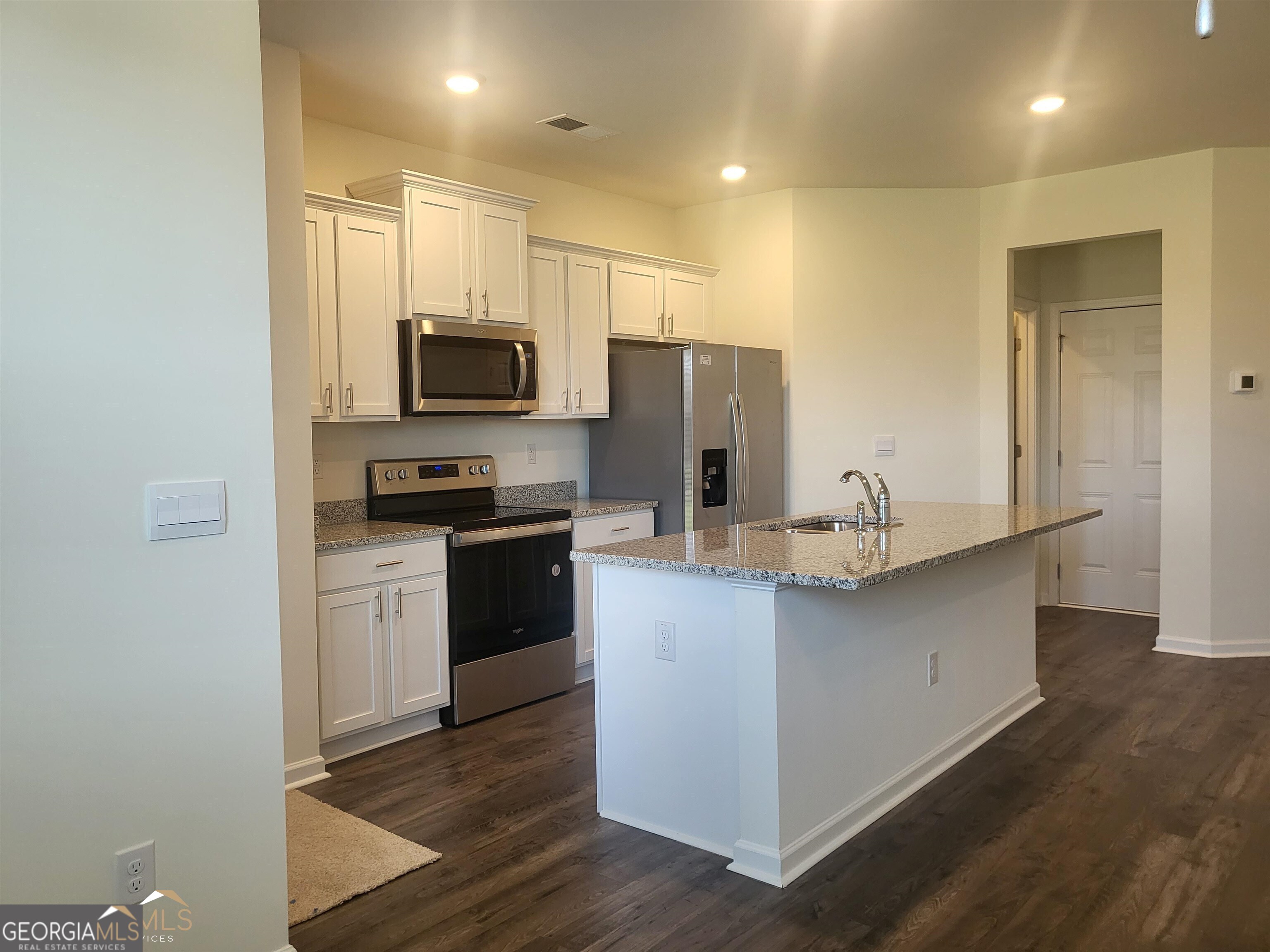 839 Taurus Drive Stockbridge, GA 30281 - Photo 5 of 27 a kitchen with stainless steel appliances a refrigerator and a stove top oven