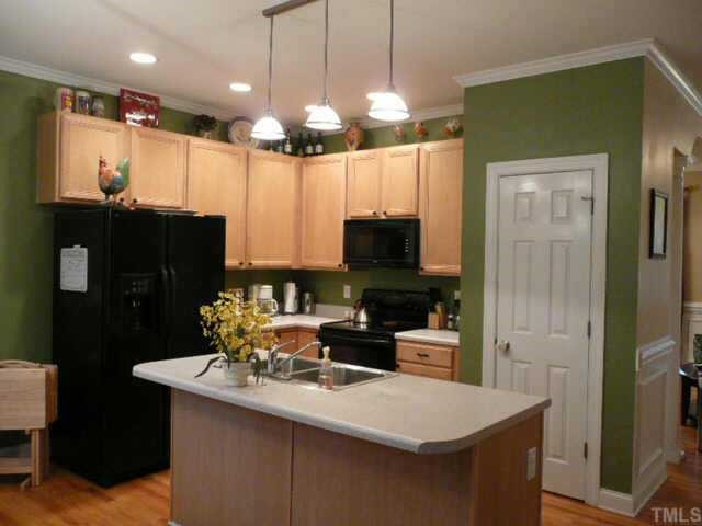 3812 April Place Raleigh, NC 27612 - Photo 3 of 12 Kitchen has center island and hardwood floors Other