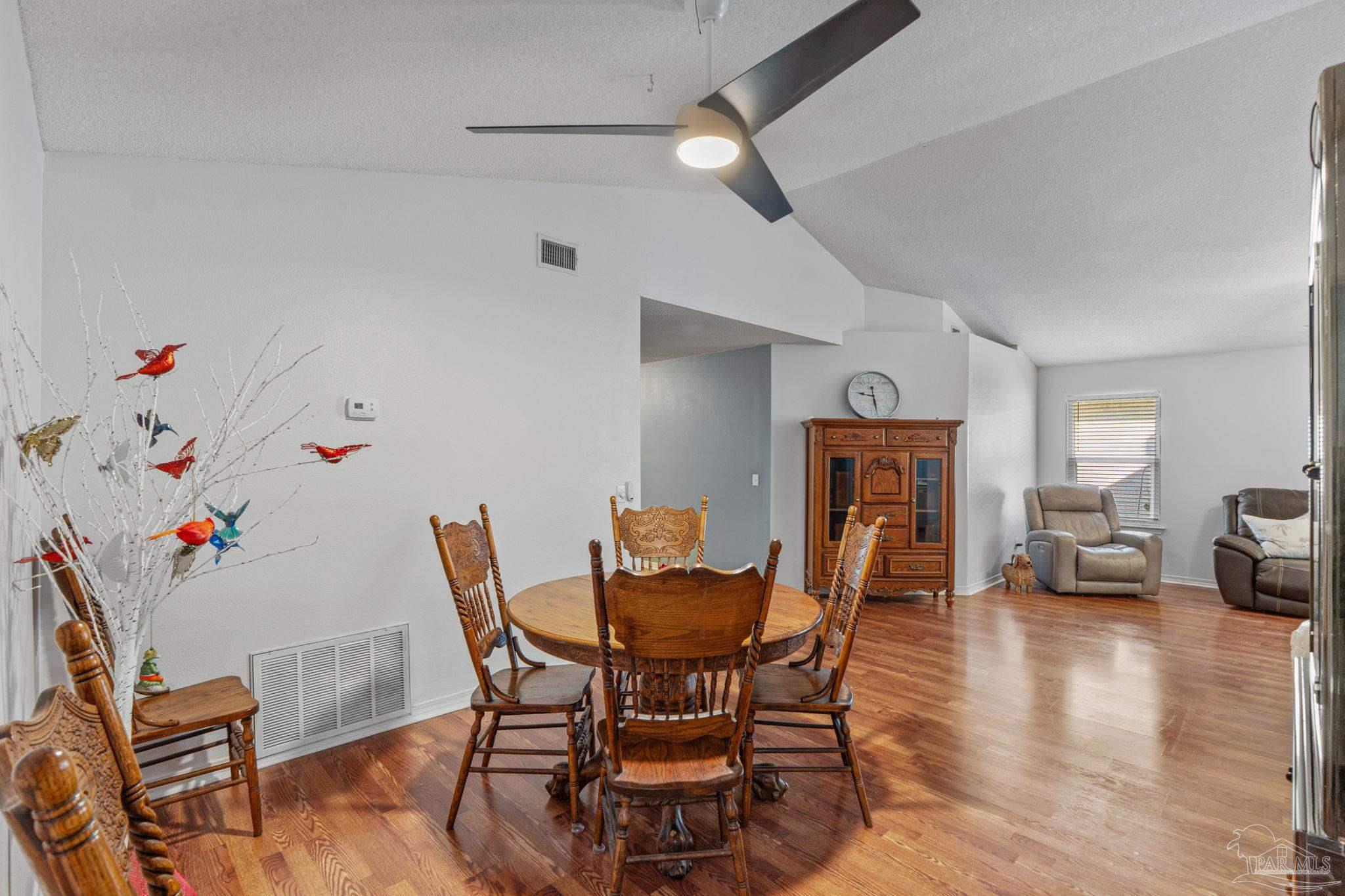 1739 Ivalea Circle Navarre, FL 32566 - Photo 12 of 46 a dining room with furniture and wooden floor