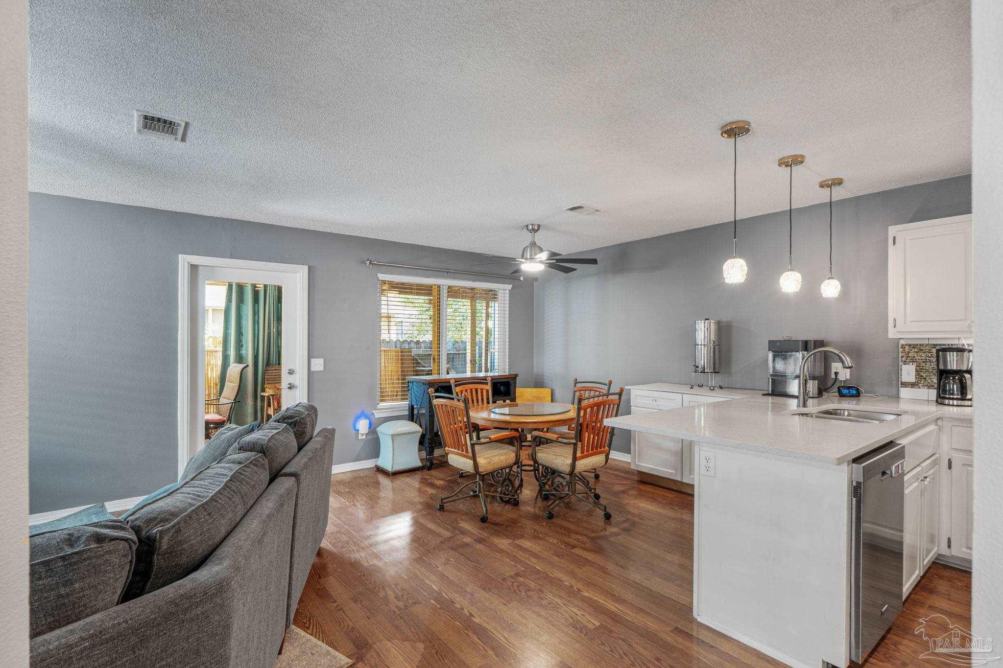1739 Ivalea Circle Navarre, FL 32566 - Photo 21 of 46 a view of a dining room with furniture window and wooden floor