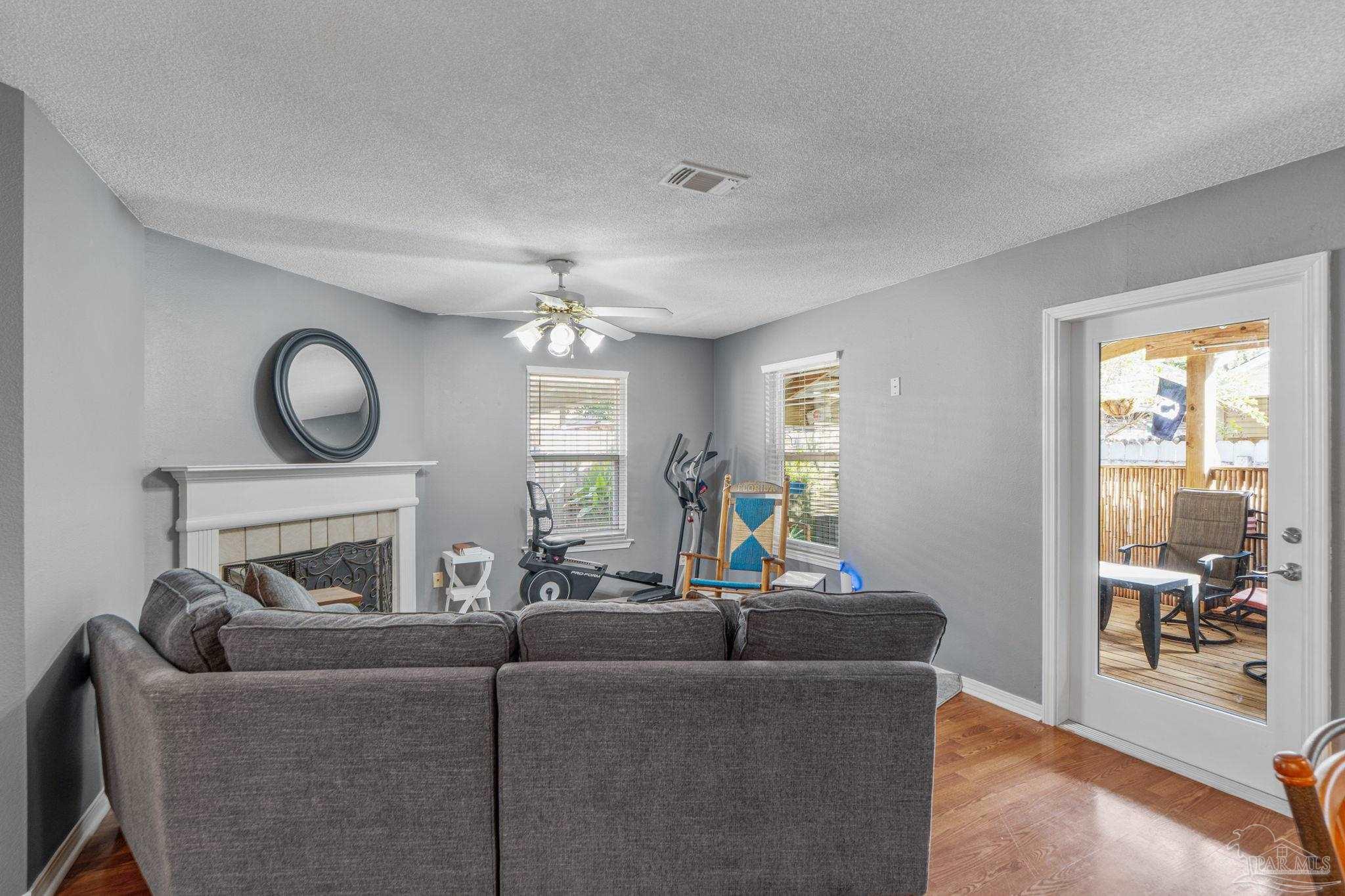 1739 Ivalea Circle Navarre, FL 32566 - Photo 22 of 46 a living room with furniture a fireplace and a floor to ceiling window