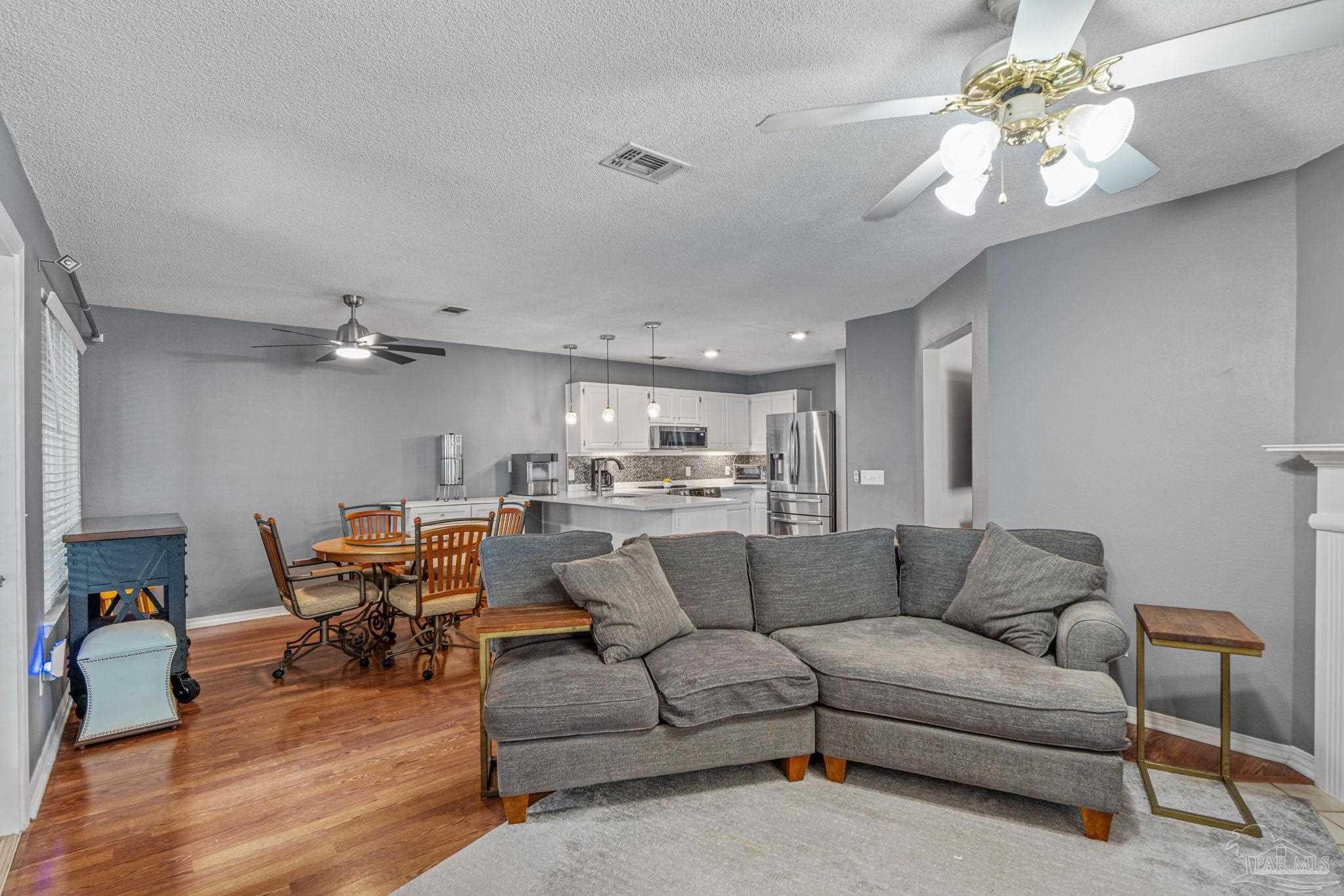 1739 Ivalea Circle Navarre, FL 32566 - Photo 24 of 46 a living room with furniture and a chandelier