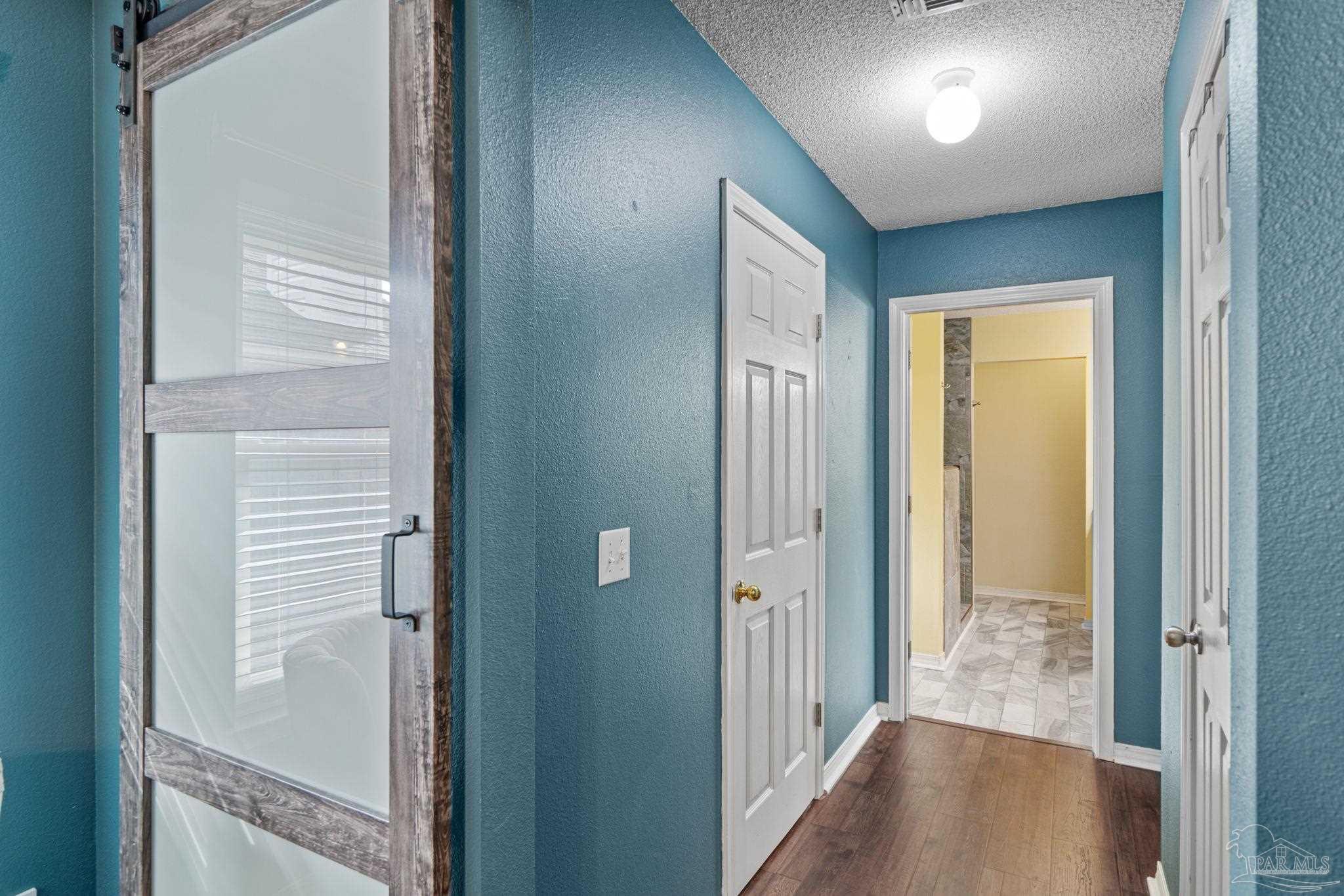 1739 Ivalea Circle Navarre, FL 32566 - Photo 29 of 46 a view of a hallway with wooden floor