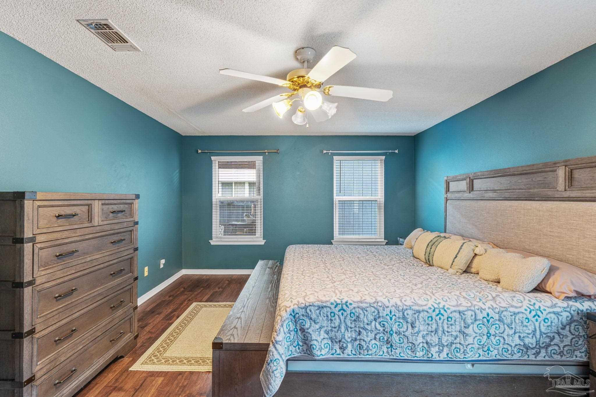 1739 Ivalea Circle Navarre, FL 32566 - Photo 31 of 46 a bedroom with a bed and wooden floor