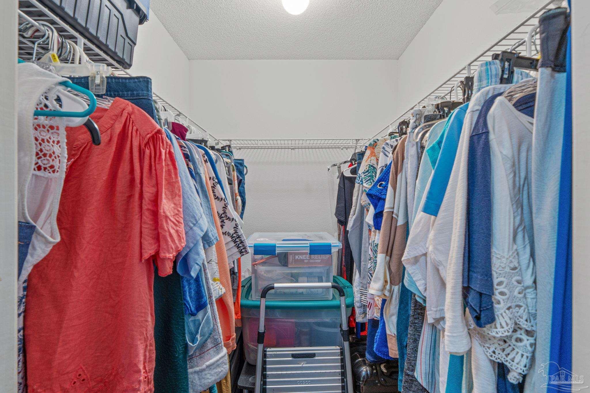 1739 Ivalea Circle Navarre, FL 32566 - Photo 32 of 46 a view of walk in closet with clothes