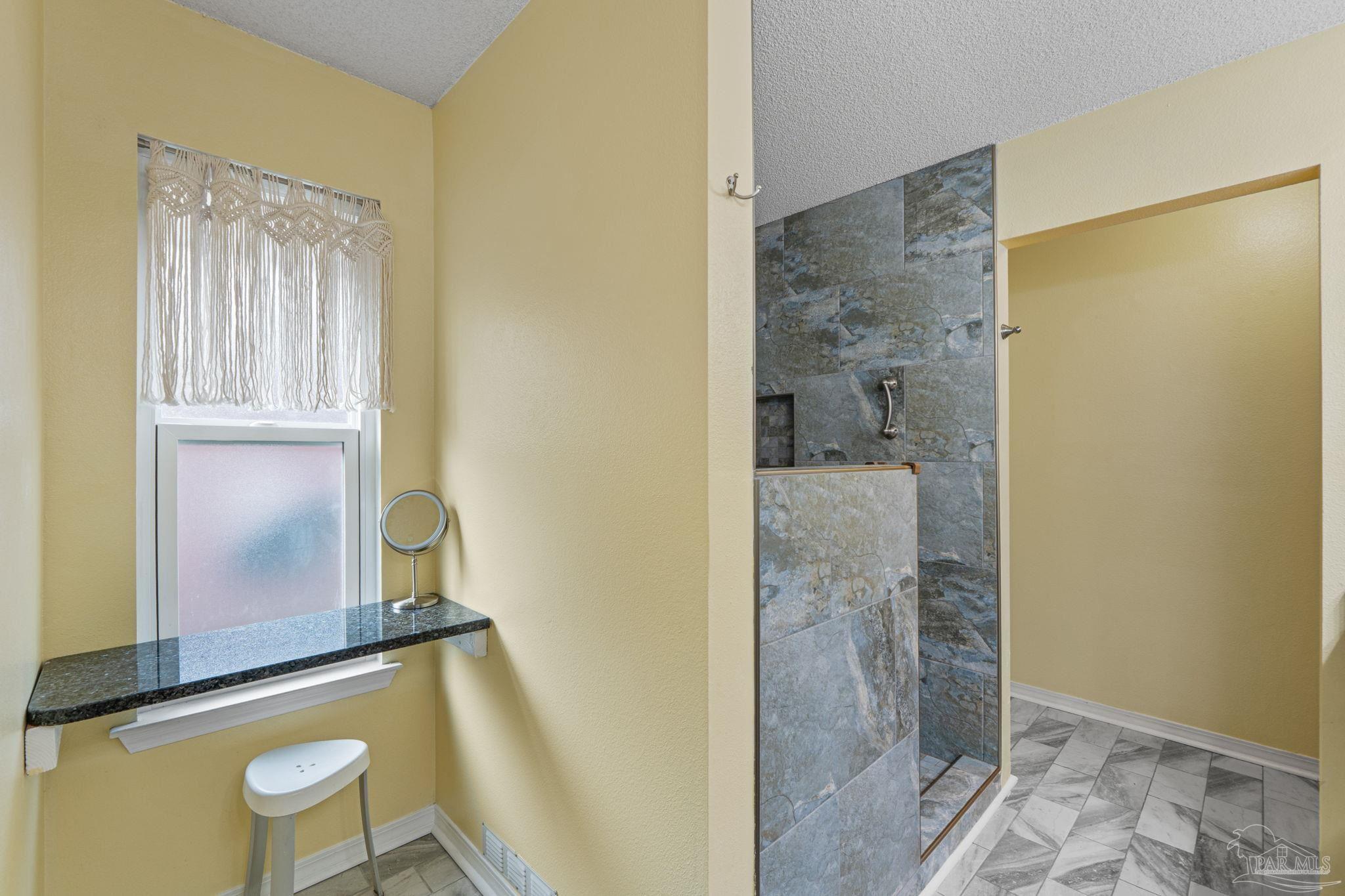 1739 Ivalea Circle Navarre, FL 32566 - Photo 36 of 46 a bathroom with a granite countertop shower a toilet and a sink