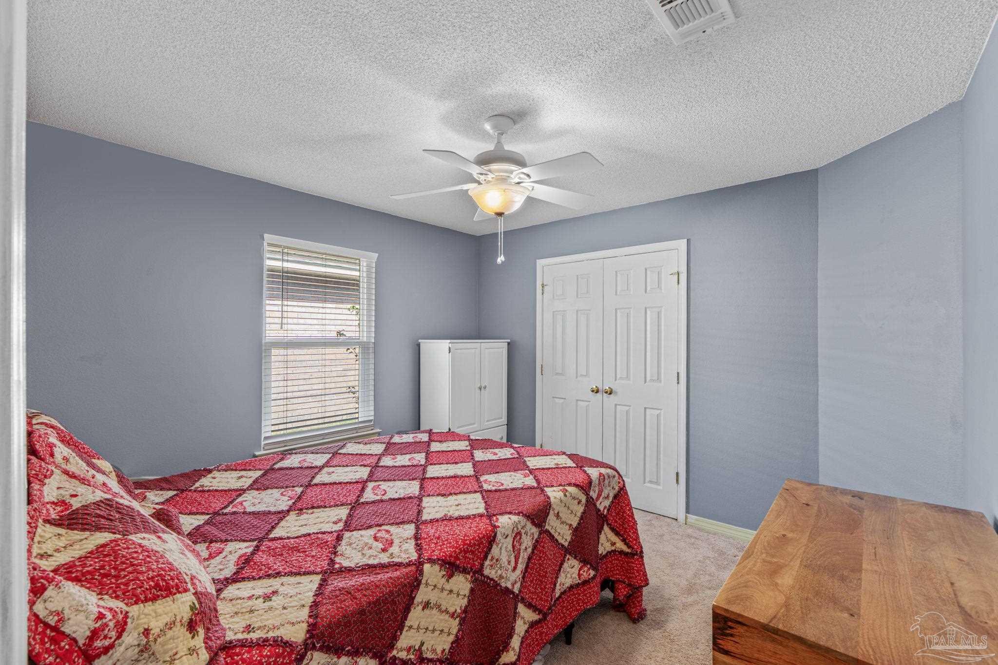 1739 Ivalea Circle Navarre, FL 32566 - Photo 39 of 46 a bedroom with a bed and a chandelier