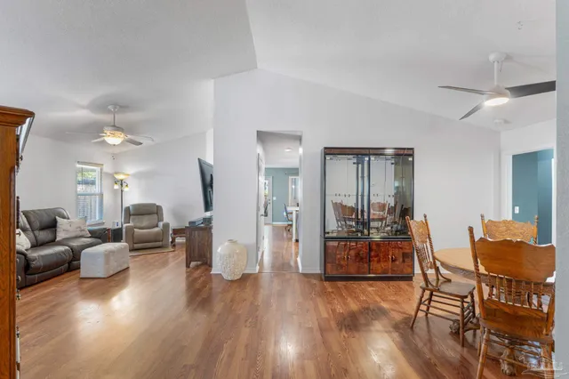 a view of a dining room with furniture and wooden floor