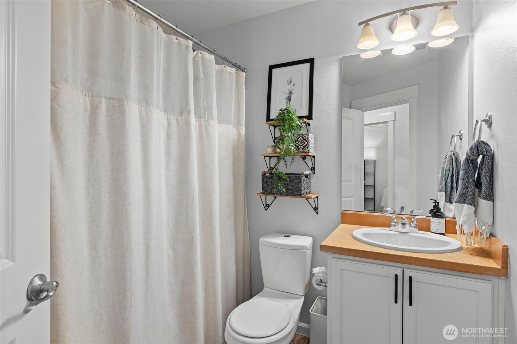 37523 Southeast Fury Street Snoqualmie, WA 98065 - Photo 21 of 30 a bathroom with a sink a toilet and shower curtain