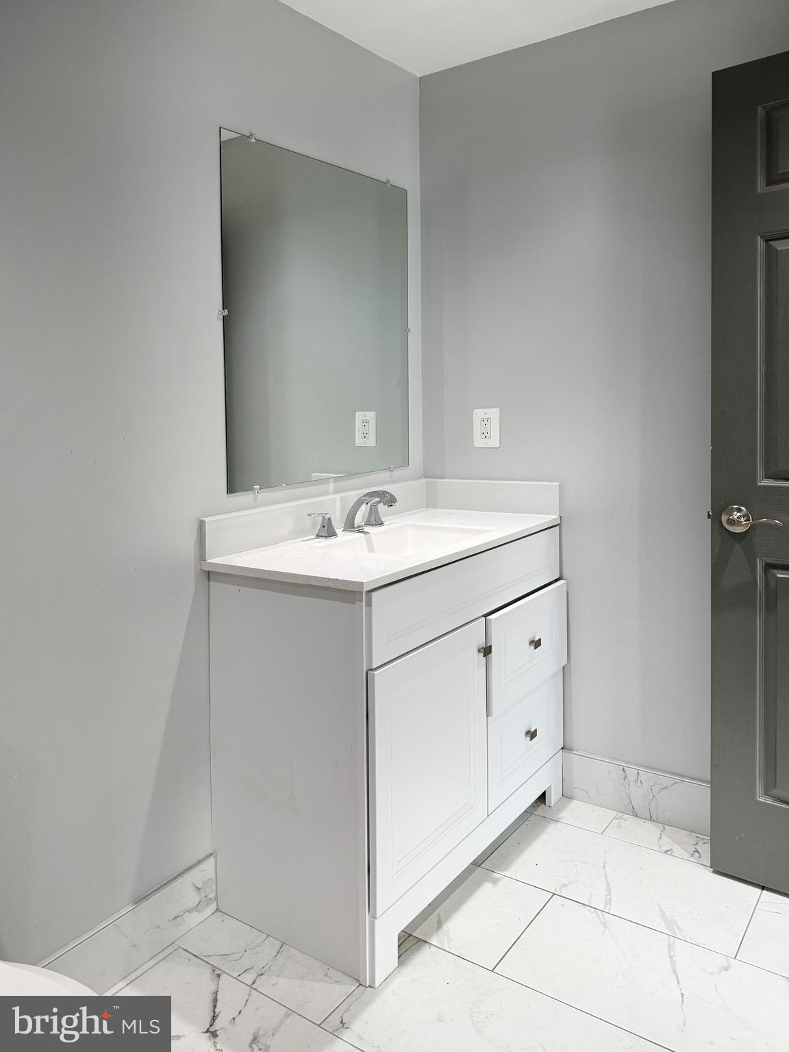 1365 Wisconsin Avenue Northwest, Unit 2 Washington, DC 20007 - Photo 12 of 14 a utility room with a sink a vanity and a mirror