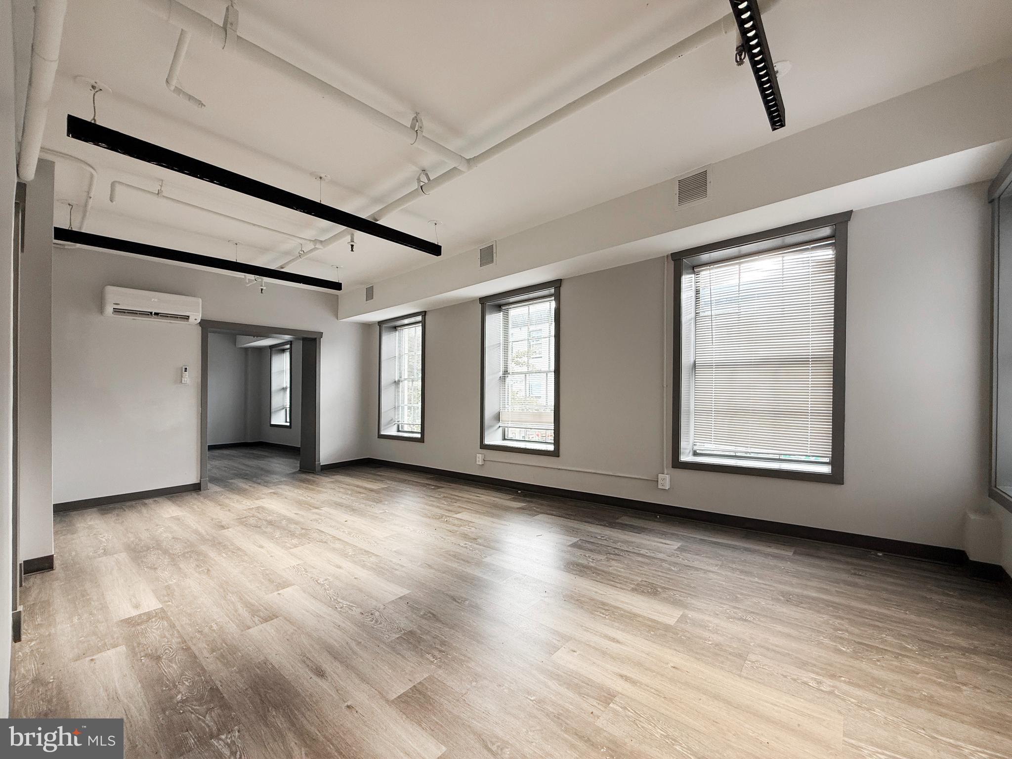 1365 Wisconsin Avenue Northwest, Unit 2 Washington, DC 20007 - Photo 2 of 14 a view of an empty room with wooden floor and window