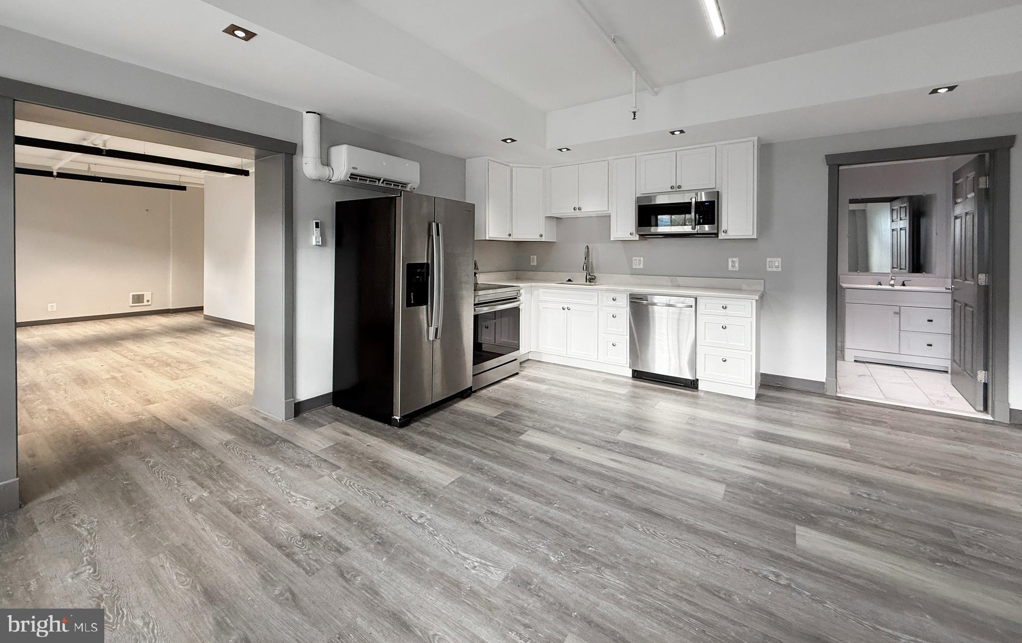 1365 Wisconsin Avenue Northwest, Unit 2 Washington, DC 20007 - Photo 5 of 14 a view of kitchen with stainless steel appliances refrigerator stove microwave and cabinets