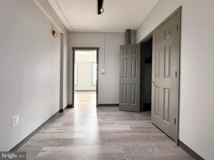 a view of a hallway with wooden floor