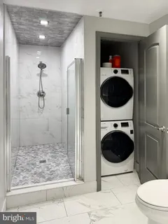 a bathroom with a toilet and a shower