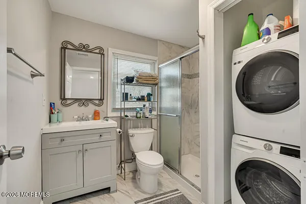 a bathroom with a toilet sink vanity and mirror