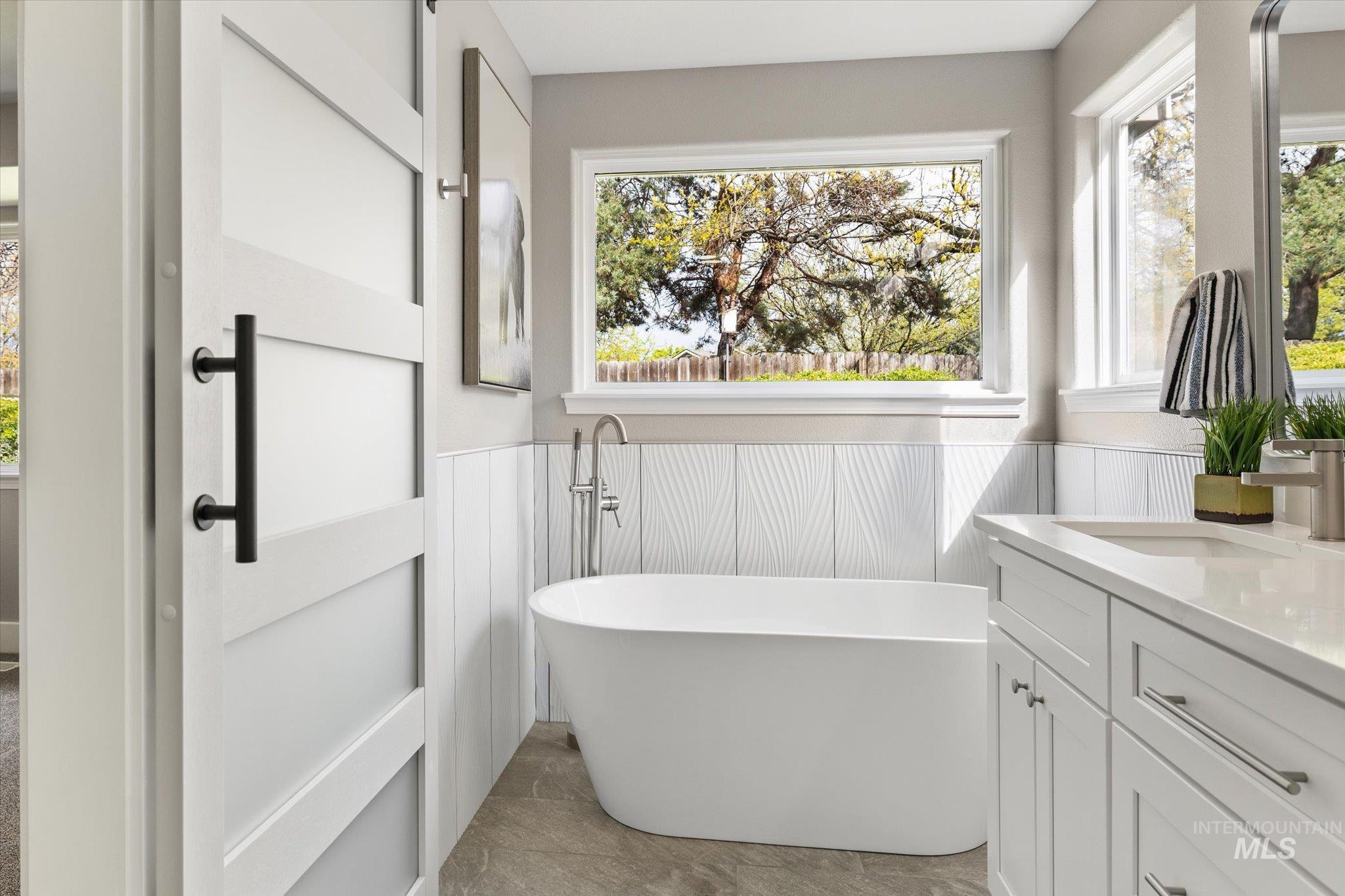2250 North Amethyst Avenue Meridian, ID 83646 - Photo 32 of 50 Bathroom with wainscoting, vanity, and a freestanding tub