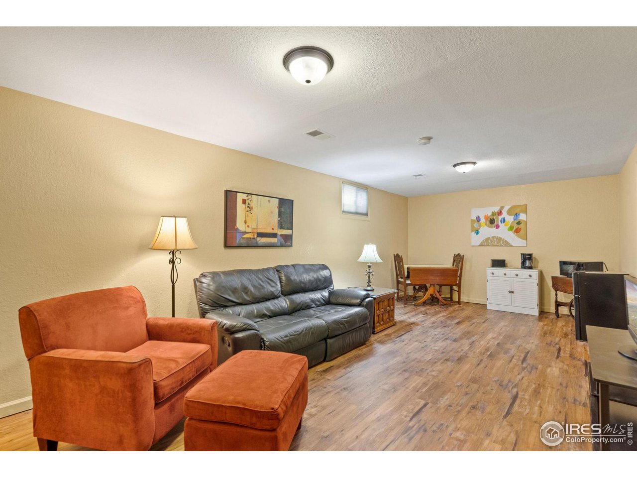 2 Spruce Court Windsor, CO 80550 - Photo 20 of 31 Warm paint and laminate floors brighten this basement space