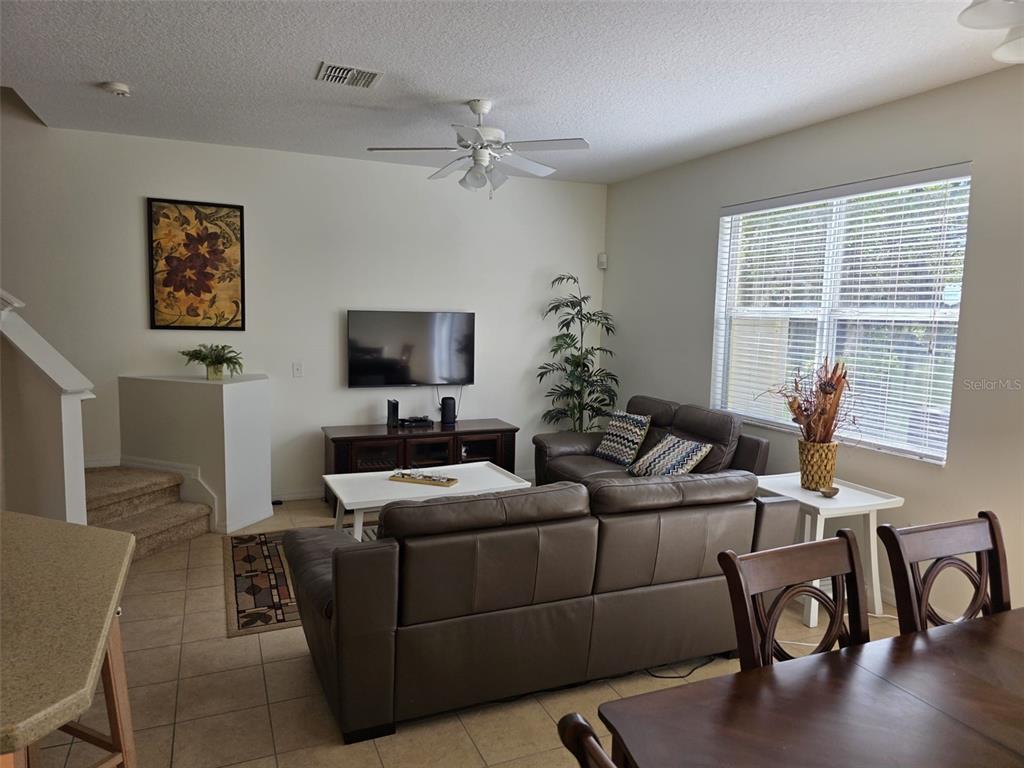 5160 Ambergris Loop Kissimmee, FL 34746 - Photo 13 of 38 a living room with furniture and a flat screen tv