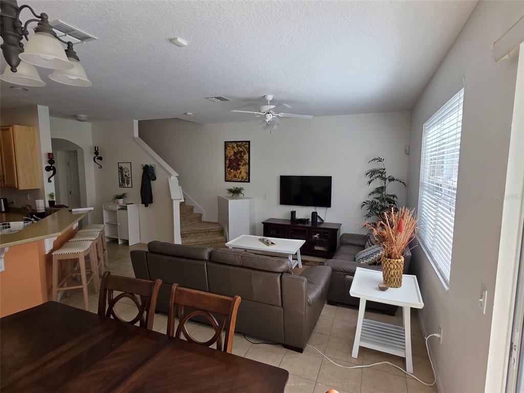 5160 Ambergris Loop Kissimmee, FL 34746 - Photo 14 of 38 a view of a workspace with furniture and a flat screen tv
