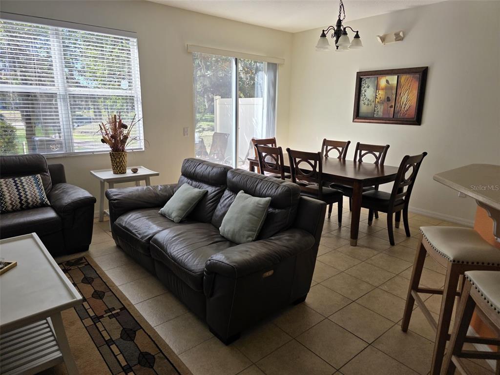 5160 Ambergris Loop Kissimmee, FL 34746 - Photo 15 of 38 a living room with furniture wooden floor and a large window