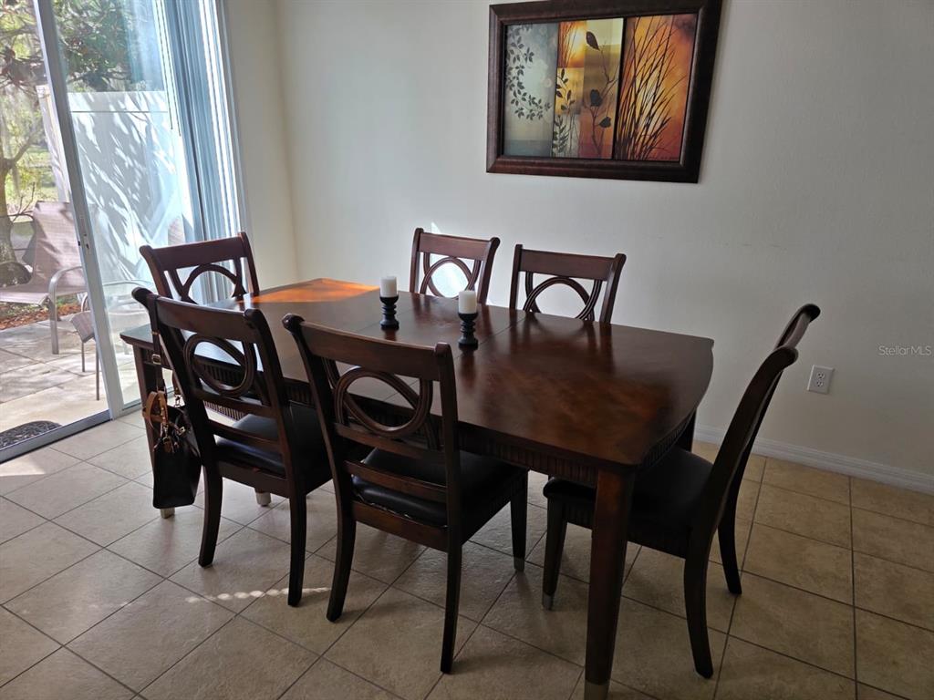 5160 Ambergris Loop Kissimmee, FL 34746 - Photo 16 of 38 a view of a dining room with furniture and window
