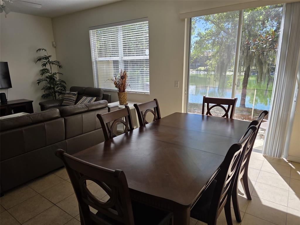 5160 Ambergris Loop Kissimmee, FL 34746 - Photo 17 of 38 a view of a dining room with furniture and window