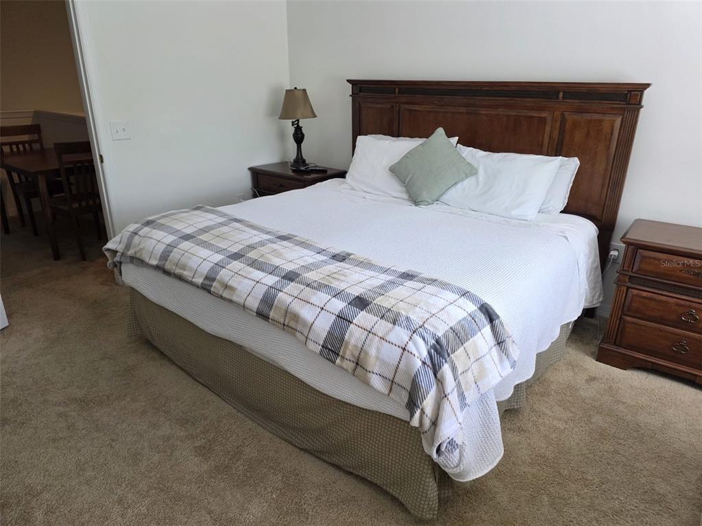 5160 Ambergris Loop Kissimmee, FL 34746 - Photo 20 of 38 a large bed sitting in a bedroom next to a lamp