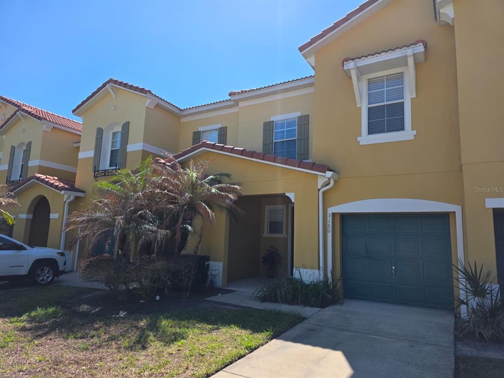 5160 Ambergris Loop Kissimmee, FL 34746 - Photo 2 of 38 a view of a house with a yard