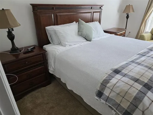 a bedroom with a bed and a mirror
