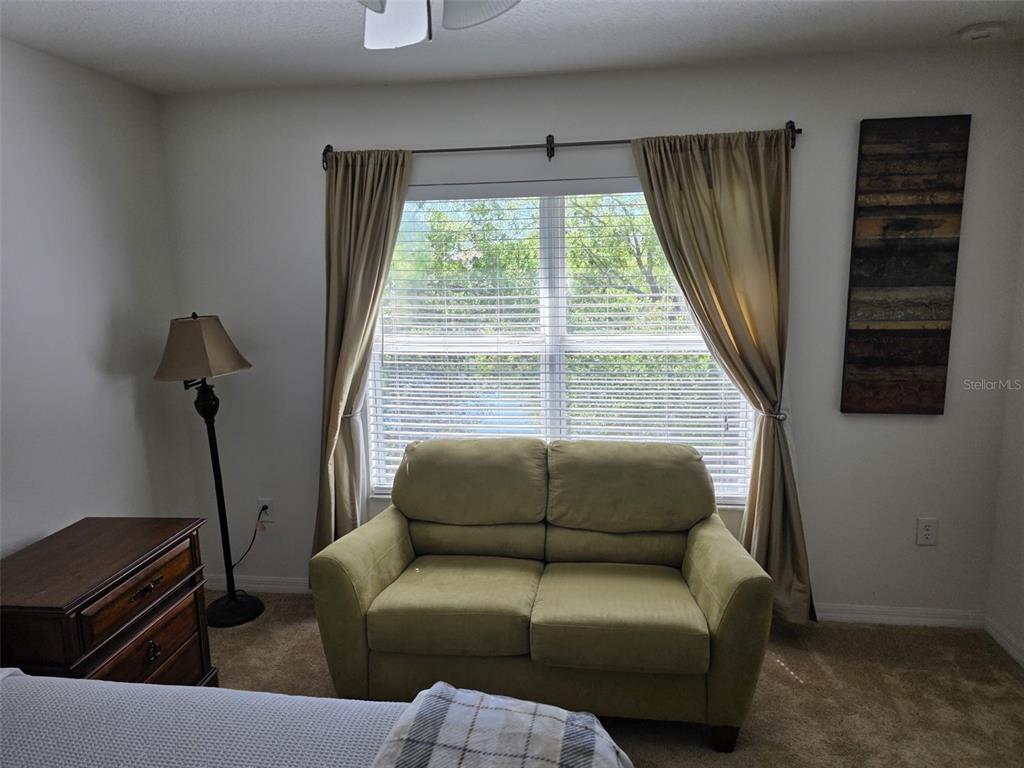 5160 Ambergris Loop Kissimmee, FL 34746 - Photo 22 of 38 a living room with furniture and a window