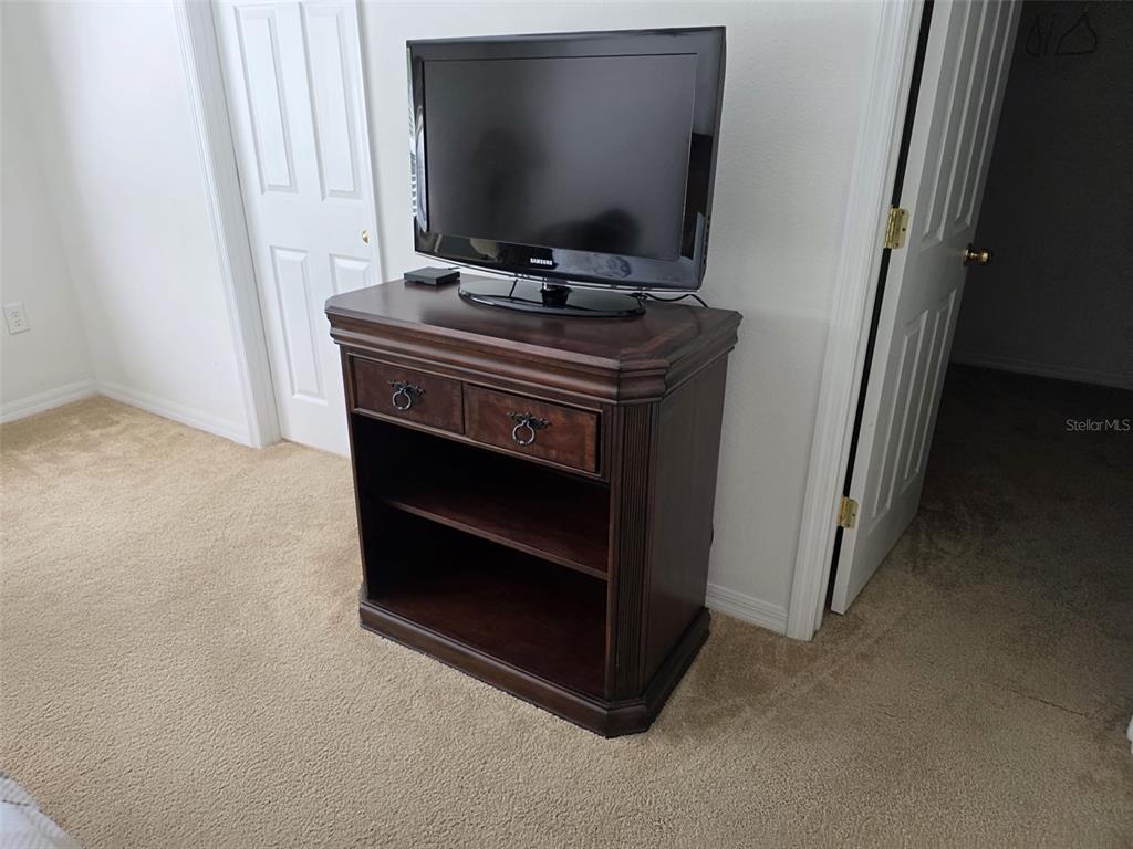 5160 Ambergris Loop Kissimmee, FL 34746 - Photo 25 of 38 a room with furniture and flat screen tv