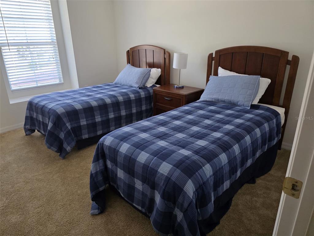 5160 Ambergris Loop Kissimmee, FL 34746 - Photo 28 of 38 a bedroom with two beds and a dresser