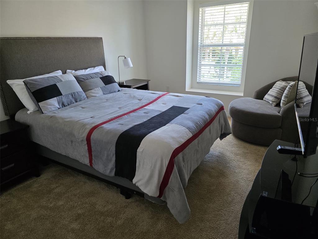 5160 Ambergris Loop Kissimmee, FL 34746 - Photo 29 of 38 a bedroom with a bed and window