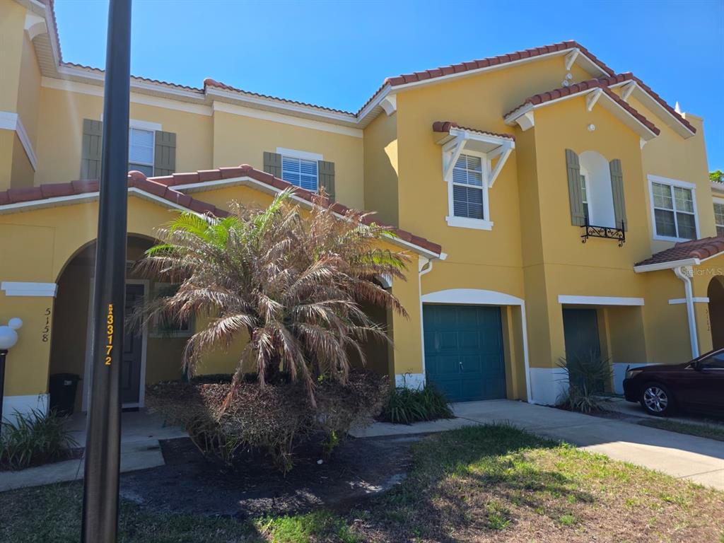 5160 Ambergris Loop Kissimmee, FL 34746 - Photo 3 of 38 a front view of a house with garden