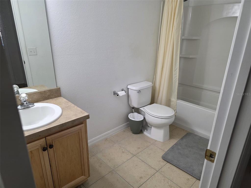 5160 Ambergris Loop Kissimmee, FL 34746 - Photo 31 of 38 a bathroom with a sink toilet and a mirror