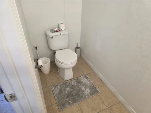 a white toilet sitting next to a white sink