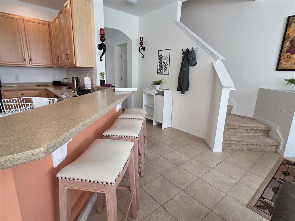 5160 Ambergris Loop Kissimmee, FL 34746 - Photo 10 of 38 a kitchen with stainless steel appliances granite countertop a refrigerator and a stove