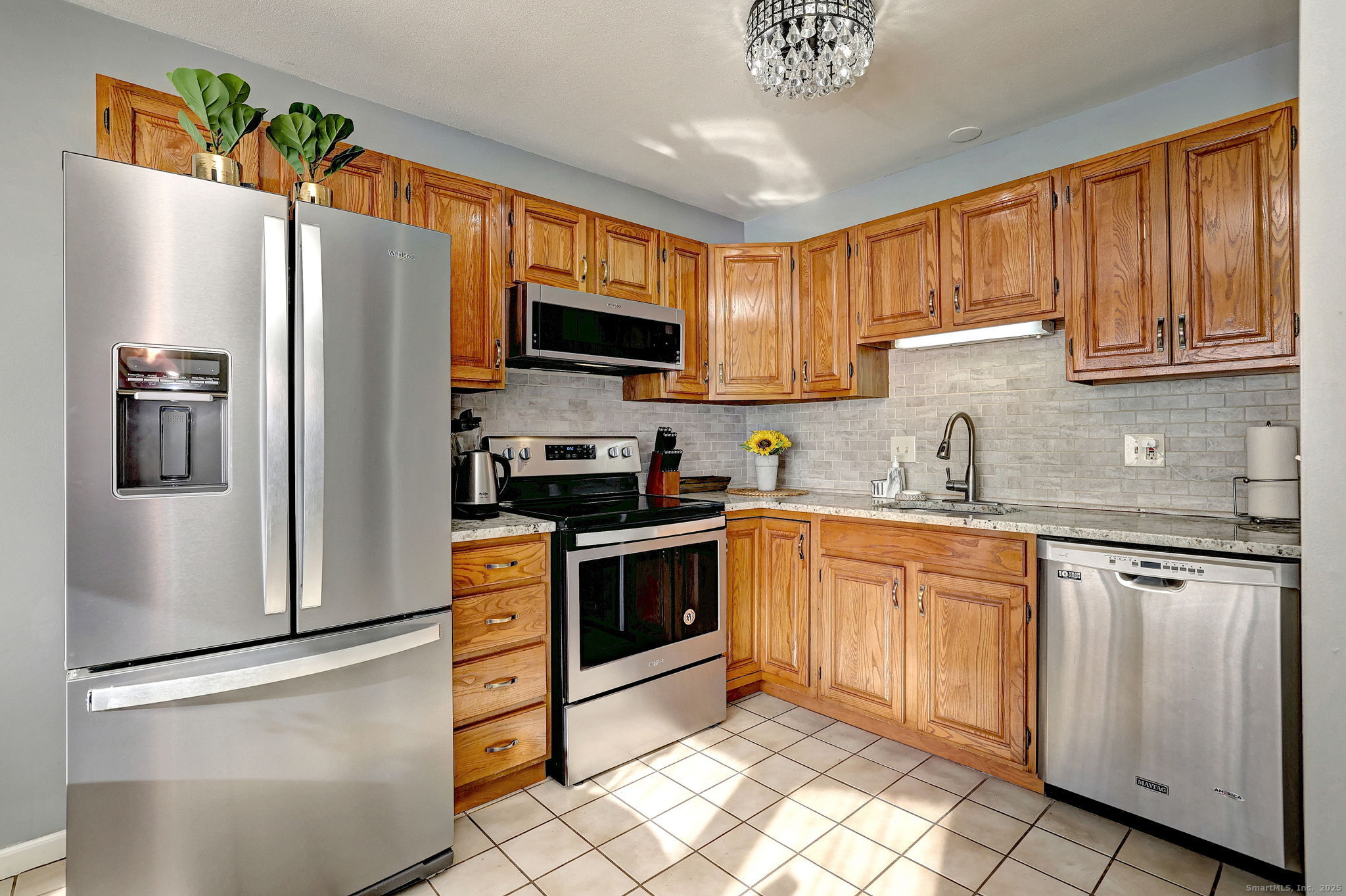 2838 Whitney Avenue, Unit 2 Hamden, CT 06518 - Photo 11 of 26 a kitchen with stainless steel appliances granite countertop a refrigerator stove microwave and sink