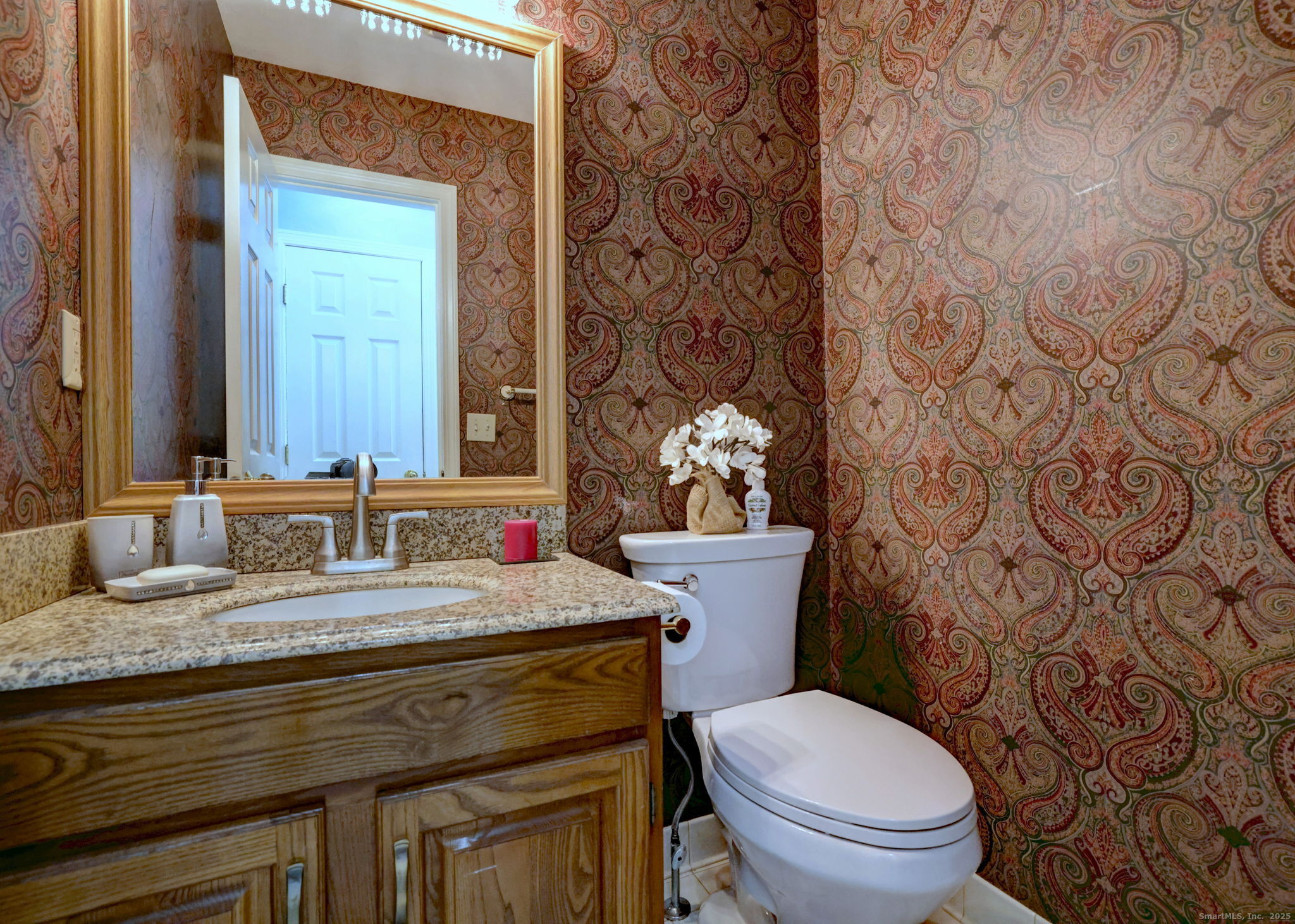 2838 Whitney Avenue, Unit 2 Hamden, CT 06518 - Photo 13 of 26 a bathroom with a granite countertop toilet sink and mirror