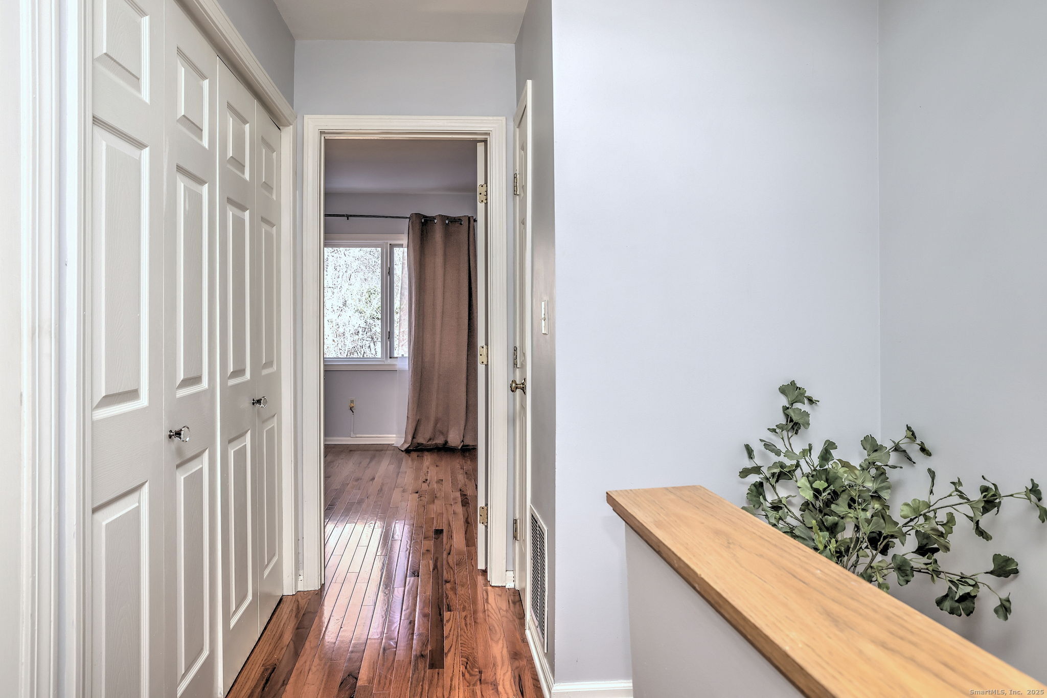 2838 Whitney Avenue, Unit 2 Hamden, CT 06518 - Photo 19 of 26 a view of a hallway with wooden floor and stairs