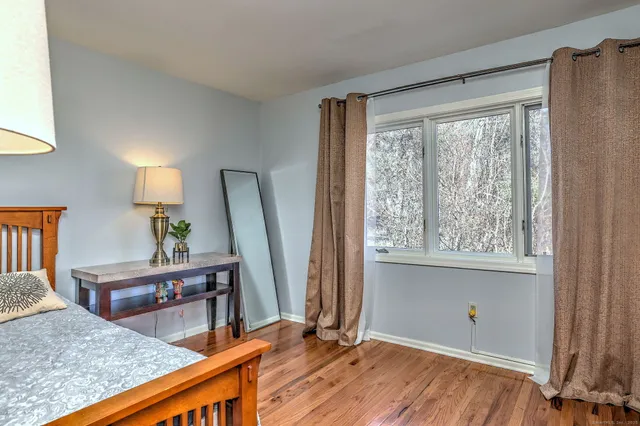 a bedroom with a bed and a desk in it