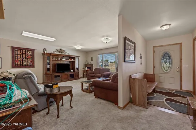 a living room with furniture a couch and a flat screen tv