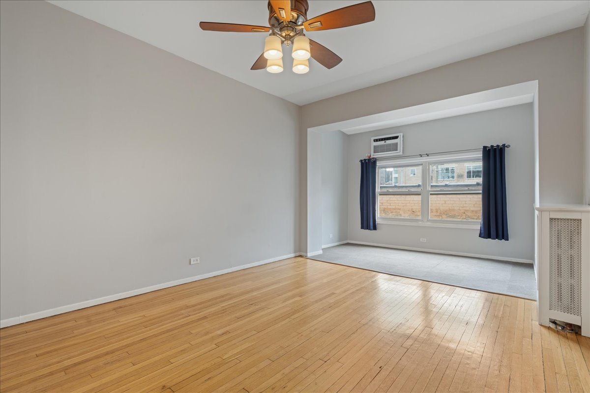 609 West Melrose Street, Unit 2 Chicago, IL 60657 - Photo 11 of 16 a view of an empty room with window and wooden floor