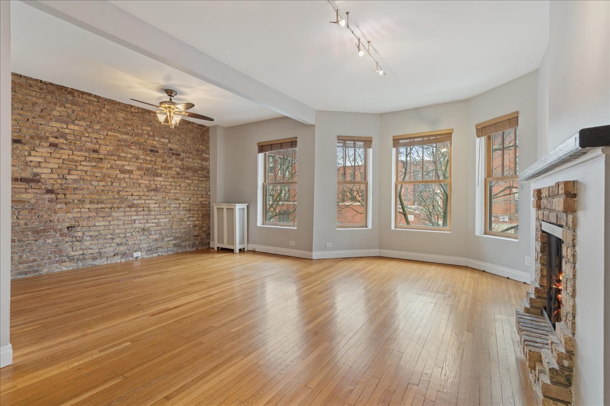 609 West Melrose Street, Unit 2 Chicago, IL 60657 - Photo 2 of 16 a view of an empty room with a window and wooden floor