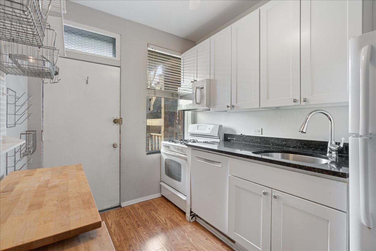 609 West Melrose Street, Unit 2 Chicago, IL 60657 - Photo 8 of 16 a kitchen with stainless steel appliances granite countertop a sink stove and refrigerator