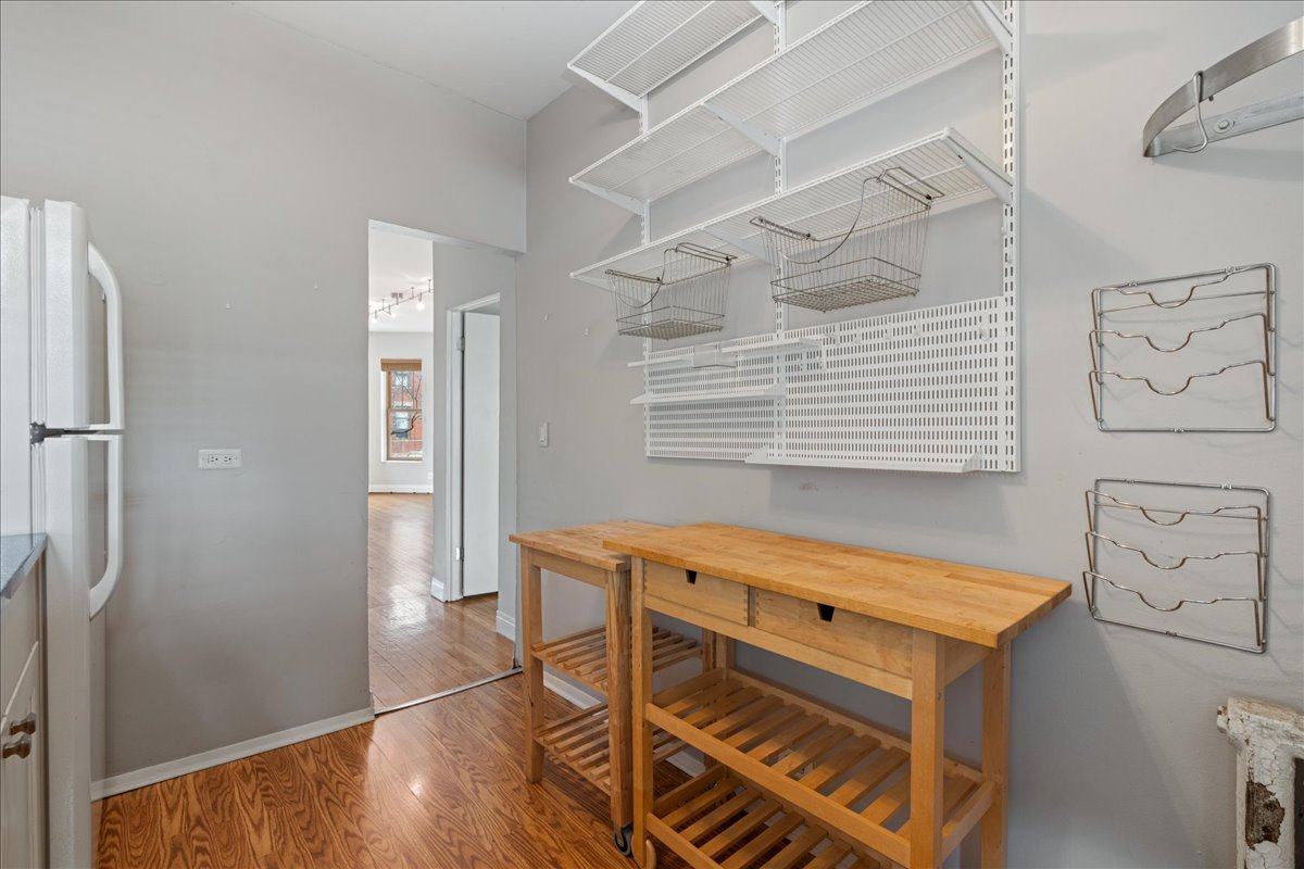 609 West Melrose Street, Unit 2 Chicago, IL 60657 - Photo 10 of 16 a view of an empty room with wooden floor and a window